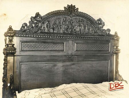 A LARGE DOUBLE BED SHOWING THE DETAILS OF THE WOOD CARVING