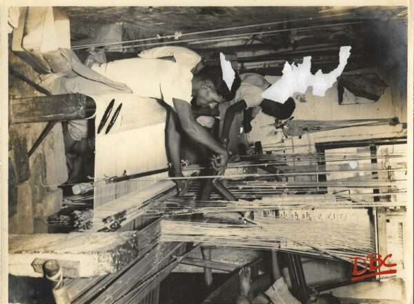 WEAVERS WORKING IN THE LOOMS