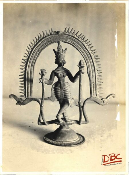 standing femal holding flower stalk by both the hands with in a steel (brass)