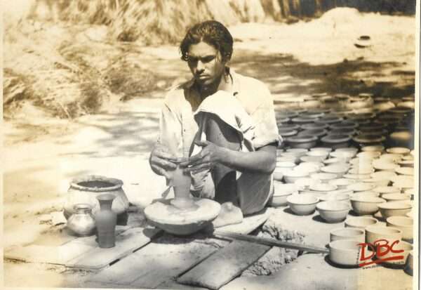 potter marking earthenware vessel