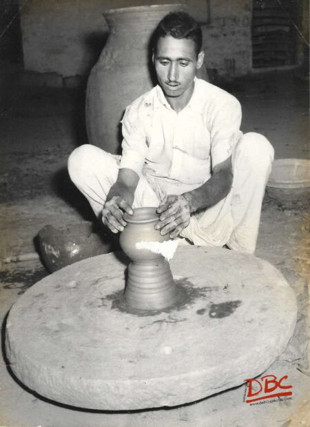 potter making clay jar
