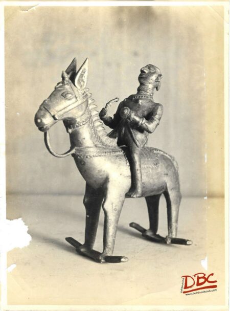 rider on hours (toy ) holding reins with left hand (brass)