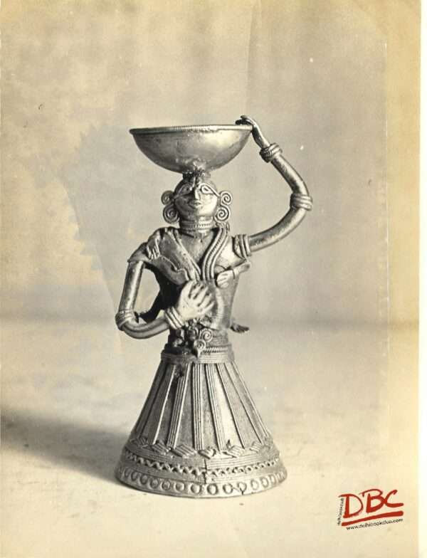 female lakous with a basket on her head dhokre art ( brass ) w. bengal