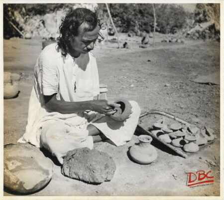 A Craftsman Preparing Clay Models for Casting