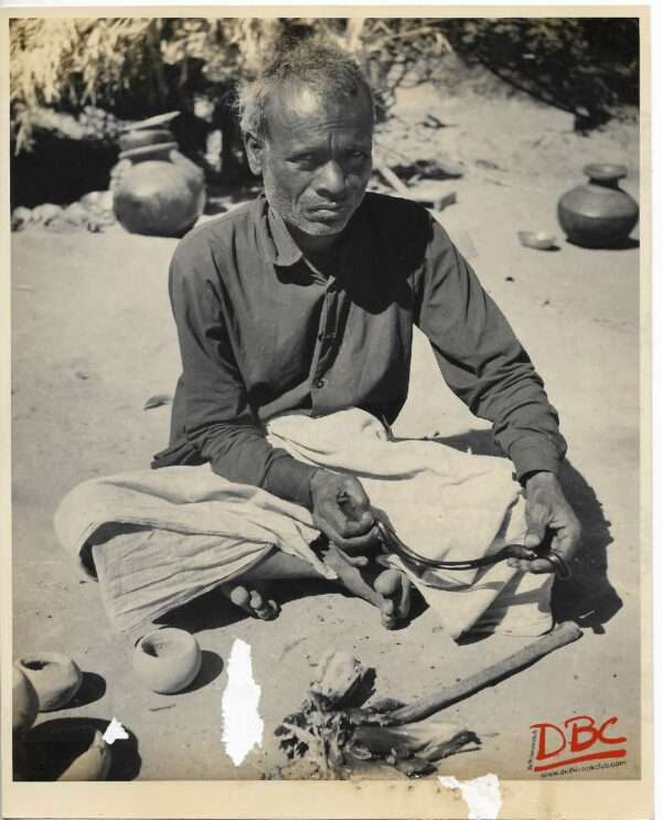 A Craftsman Turing A Metal Chain Into