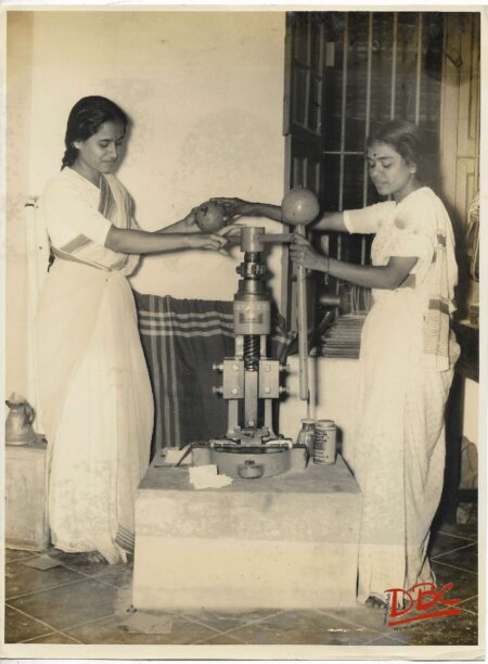 Two Ladies Working on Macine
