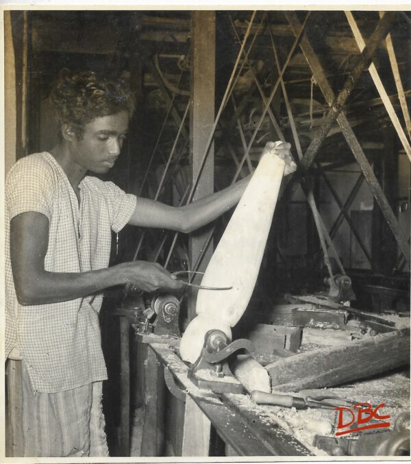 A Craftsman Measuring The Span of An Article