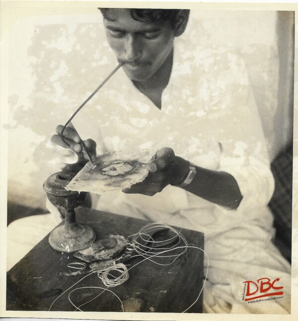 A Craftsman Working With a Pipe on Flame