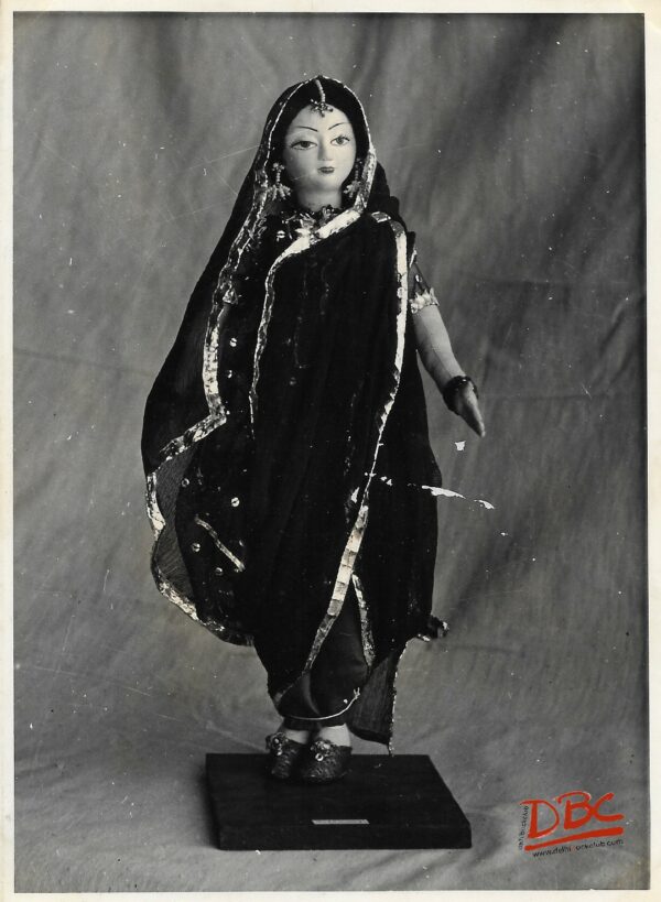 A Doll Standing on a Platform