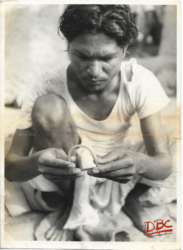A Craftsman Working With A Metal Chain