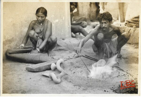 A Craftsman & Woman Preparing Mould on Fire