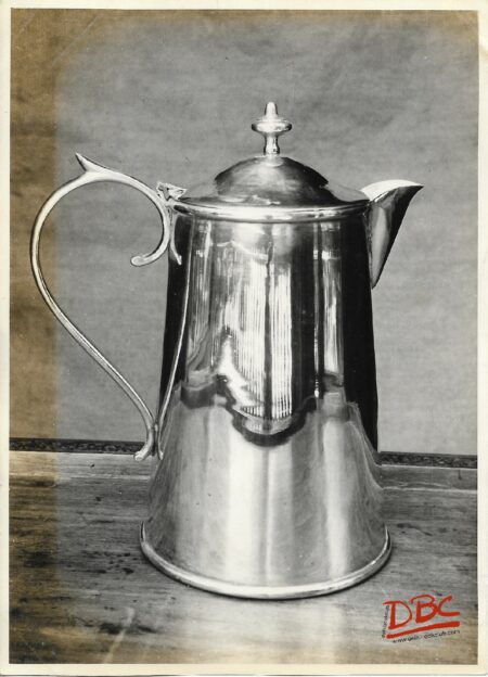 A Metalic Jug With A Handle