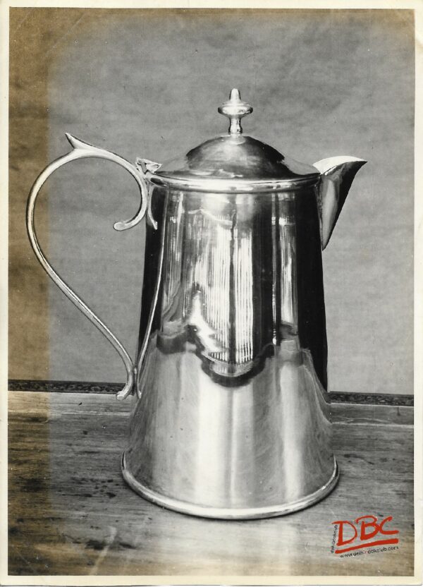 A Metalic Jug With A Handle