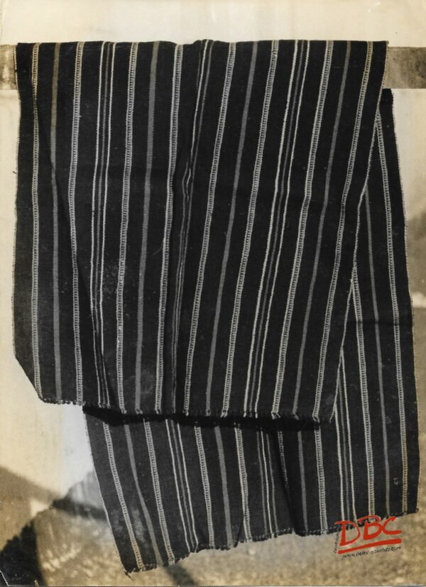 I Khyng A Strinp Of hand Woven Black Course Cotton cloth Eith Red And White Strips All Over The Lady Worn By The Woman As A Skirt