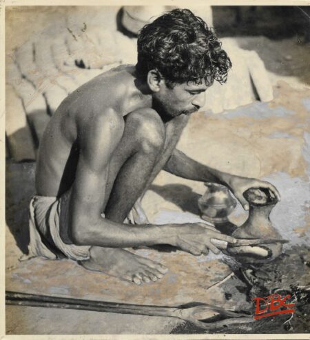 A Craftsman Cutting a Clay Mould