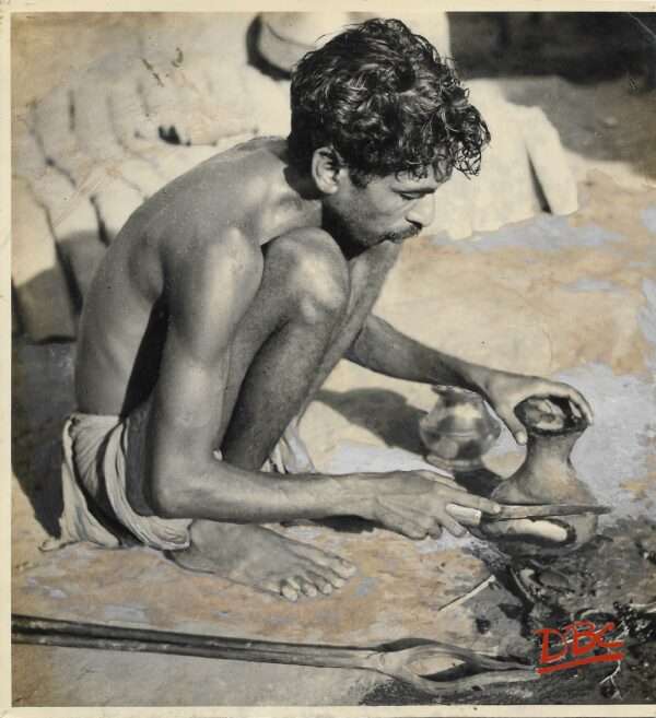 A Craftsman Cutting a Clay Mould